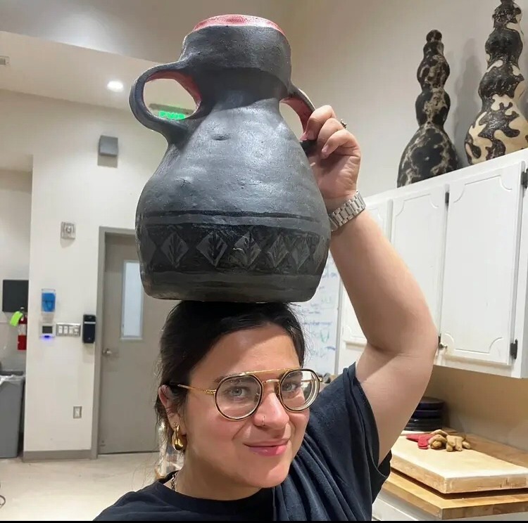 Posing with a Jarra - clay pot traditionally made with terracotta and used to transport and cool water