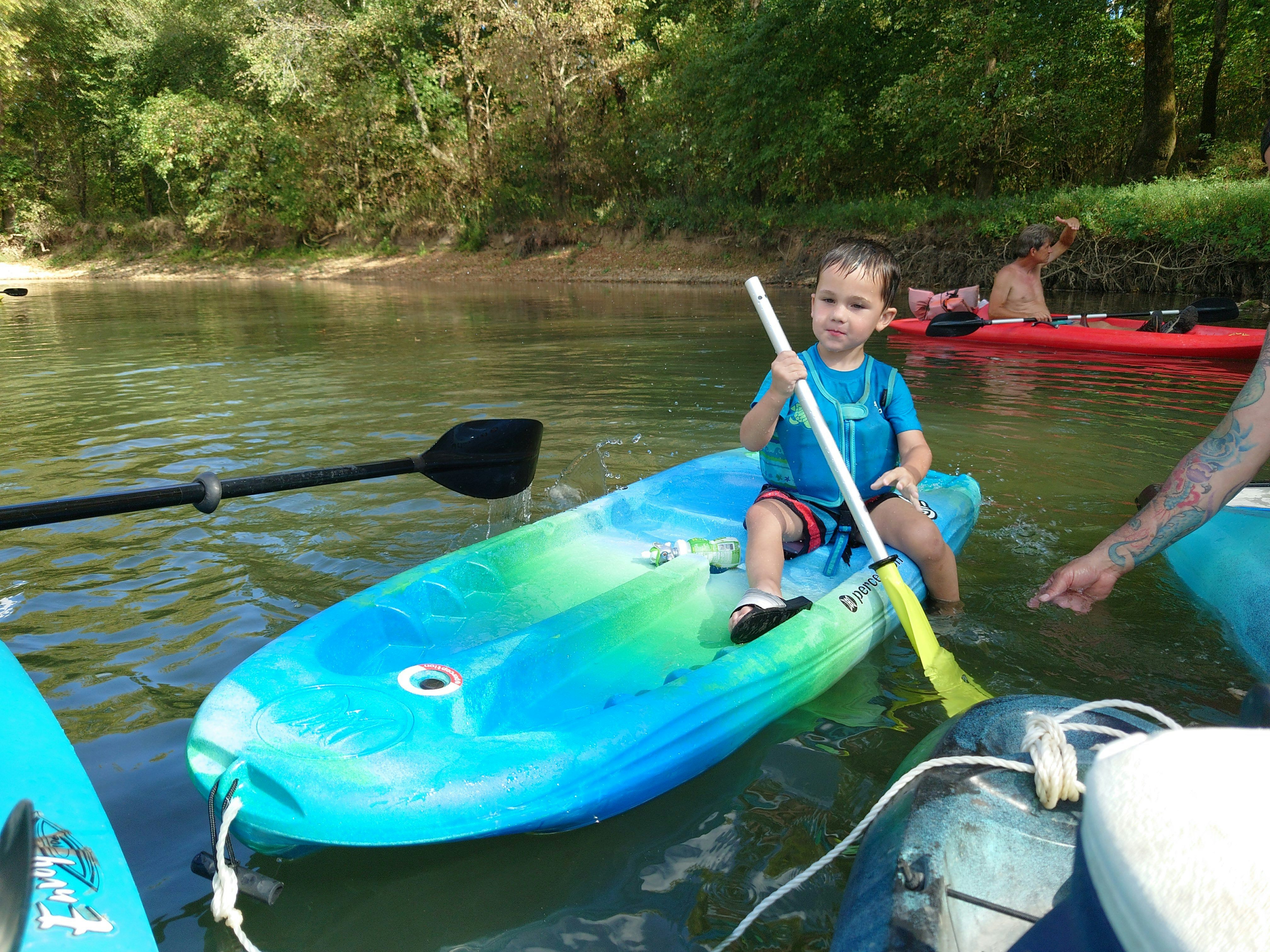 His son's first time in his kayak on the river.